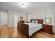 Cozy bedroom with wood floors, neutral walls, and natural light from the large windows at 622 Sunset Ave, Apex, NC 27502