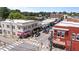 Elevated angle captures downtown buildings at an intersection, showcasing pedestrian-friendly crosswalks and local businesses at 622 Sunset Ave, Apex, NC 27502