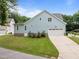 Light blue home with a two-car garage and freshly manicured lawn at 622 Sunset Ave, Apex, NC 27502