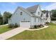 Lovely blue home featuring a white garage door and landscaped yard at 622 Sunset Ave, Apex, NC 27502