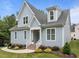Beautiful blue home with a landscaped yard, white trim, and inviting front entrance at 622 Sunset Ave, Apex, NC 27502
