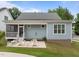 Back exterior view showing a patio, a screened porch, and a well-maintained lawn at 622 Sunset Ave, Apex, NC 27502