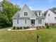 Charming blue two-story home with manicured lawn, landscaped garden, and inviting entryway at 622 Sunset Ave, Apex, NC 27502