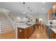 Spacious kitchen with granite counters, stainless appliances, and seamless flow into the living area at 622 Sunset Ave, Apex, NC 27502