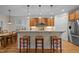 Bright eat-in kitchen features wood cabinets, stainless appliances, a breakfast bar, and lots of natural light at 622 Sunset Ave, Apex, NC 27502