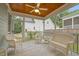 Screened porch with white wicker furniture, ceiling fan, and view of backyard at 622 Sunset Ave, Apex, NC 27502