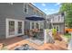 Outdoor back deck with dining set, umbrella, and access to a beautiful backyard space at 6304 Ansley Ln, Raleigh, NC 27612
