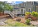 Charming backyard with a deck, patio, fire pit, and lush greenery, perfect for outdoor living at 6304 Ansley Ln, Raleigh, NC 27612