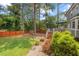 Spacious backyard with a deck, fire pit, and mature trees, offering a private outdoor retreat at 6304 Ansley Ln, Raleigh, NC 27612