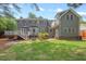 Spacious backyard with a deck, patio, and well-maintained lawn at 6304 Ansley Ln, Raleigh, NC 27612