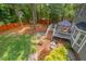 Expansive backyard featuring a deck, patio, fire pit, and lush greenery, perfect for outdoor enjoyment at 6304 Ansley Ln, Raleigh, NC 27612