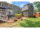 Backyard showcasing a deck, patio, fire pit, and lush landscaping, creating a perfect outdoor space at 6304 Ansley Ln, Raleigh, NC 27612