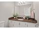 Bathroom featuring white vanity with granite countertop, modern lighting, and neutral colors at 6304 Ansley Ln, Raleigh, NC 27612