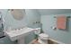 Clean bathroom featuring a white sink, modern fixtures, and blue walls at 6304 Ansley Ln, Raleigh, NC 27612