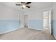 Bedroom featuring wainscotting, plush carpet, and entrances to the closet and hallway at 6304 Ansley Ln, Raleigh, NC 27612