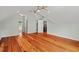 Bright bedroom featuring hardwood floors, a modern ceiling fan, and neutral colors at 6304 Ansley Ln, Raleigh, NC 27612