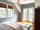Inviting bedroom featuring wood floors, french doors, and an abundance of natural light at 6304 Ansley Ln, Raleigh, NC 27612