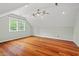 Spacious bedroom featuring hardwood floors, natural light, and a modern ceiling fan at 6304 Ansley Ln, Raleigh, NC 27612