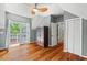 Bedroom featuring hardwood floors, natural light from a door to a deck, and a closet at 6304 Ansley Ln, Raleigh, NC 27612