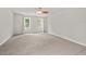 Spacious bedroom with plush carpet, ample natural light from two large windows, and a ceiling fan at 6304 Ansley Ln, Raleigh, NC 27612