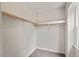 Spacious walk-in closet with ample storage featuring shelving and natural light from a window at 6304 Ansley Ln, Raleigh, NC 27612