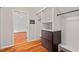 Walk-in closet with custom built-in storage and hardwood floors at 6304 Ansley Ln, Raleigh, NC 27612