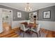 Cozy dining area featuring hardwood floors, a modern chandelier, and neutral decor at 6304 Ansley Ln, Raleigh, NC 27612