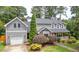 Charming two-story home with gray siding, attached garage, landscaped yard, and a welcoming front porch at 6304 Ansley Ln, Raleigh, NC 27612