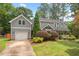 Charming two-story home with a well-maintained lawn, attached garage, and lovely landscaping at 6304 Ansley Ln, Raleigh, NC 27612