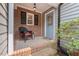 Cozy brick entrance featuring a chair and stylish front door at 6304 Ansley Ln, Raleigh, NC 27612