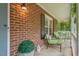 Relaxing brick front porch with chairs, plants, and a charming ambiance at 6304 Ansley Ln, Raleigh, NC 27612