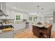 Spacious kitchen with granite counters, gas range, and breakfast bar seating at 6304 Ansley Ln, Raleigh, NC 27612