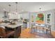 Open kitchen with island seating, modern appliances, and eat-in breakfast nook with natural light at 6304 Ansley Ln, Raleigh, NC 27612