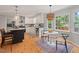 Eat-in kitchen featuring white cabinets, granite countertops, and stainless steel appliances at 6304 Ansley Ln, Raleigh, NC 27612