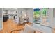 Bright kitchen with white cabinets leading to an outdoor patio with seating at 6304 Ansley Ln, Raleigh, NC 27612