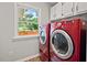 Laundry room featuring side by side red washer and dryer at 6304 Ansley Ln, Raleigh, NC 27612