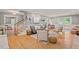 Spacious living room featuring hardwood floors, ample seating, and a staircase, perfect for Gathering gatherings at 6304 Ansley Ln, Raleigh, NC 27612