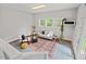 Cozy living area with comfortable seating, natural light from windows, and stylish decor at 6304 Ansley Ln, Raleigh, NC 27612