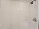 Shower with white subway tile, a chrome showerhead, and a chrome faucet handle at 6304 Ansley Ln, Raleigh, NC 27612