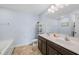 Bright bathroom featuring double sink vanity with dark cabinets and tub with modern fixtures at 6729 Osprey Landing Dr, Wendell, NC 27591