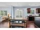 Open concept with dining table and kitchen area featuring dark cabinets and granite countertops at 6729 Osprey Landing Dr, Wendell, NC 27591