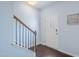 Inviting foyer with hardwood floors, decorative front door, staircase with wood railing at 6729 Osprey Landing Dr, Wendell, NC 27591