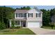 Charming two-story home with a well-manicured lawn and a welcoming front porch and two-car garage at 6729 Osprey Landing Dr, Wendell, NC 27591