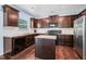 Well-appointed kitchen with dark cabinetry, granite countertops, and stainless steel appliances at 6729 Osprey Landing Dr, Wendell, NC 27591