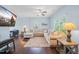 Inviting living area with hardwood floors, a large sectional sofa, and a wall-mounted TV at 6729 Osprey Landing Dr, Wendell, NC 27591