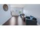 Cozy living room with hardwood floors and comfortable seating with stairs leading to other rooms at 6729 Osprey Landing Dr, Wendell, NC 27591