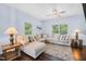 Bright living room features a neutral sectional, ceiling fan, and large windows at 6729 Osprey Landing Dr, Wendell, NC 27591