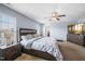 Comfortable primary bedroom with a large bed, nightstands, ceiling fan, and natural light at 6729 Osprey Landing Dr, Wendell, NC 27591