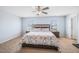 Spacious main bedroom features a ceiling fan, large windows, and carpet flooring at 6729 Osprey Landing Dr, Wendell, NC 27591