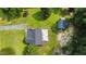 Aerial view of home with a large rear deck and seating area with a storage building in the back yard at 701 Creekside Dr, Clayton, NC 27520